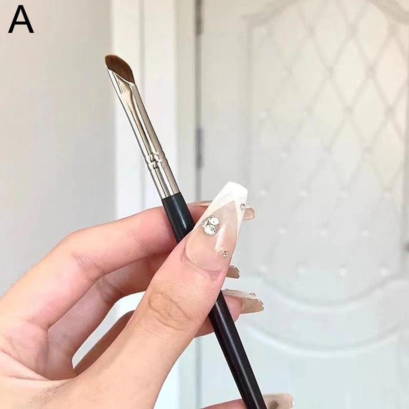 Angled blade eyeliner brush, sickle-shaped flat eyeliner brush, extending from the lower eyelid to the under-eye area, detailing eye makeup tools.